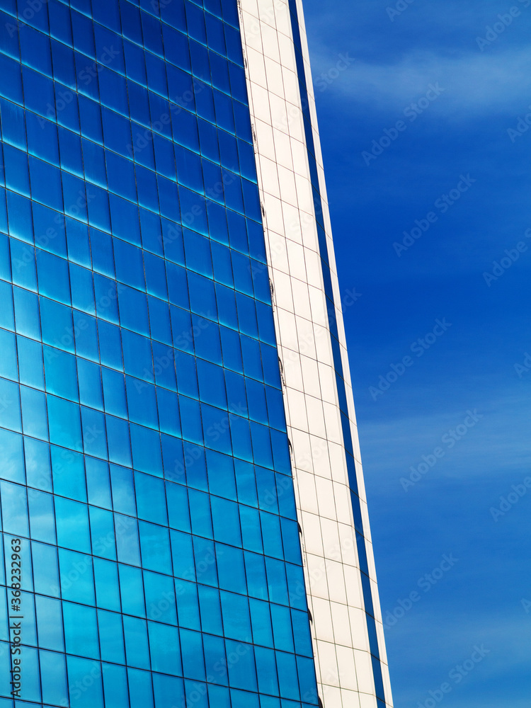 Obraz premium Bottom view of modern high rise building in the port of Odessa in the sunset at the end of the day