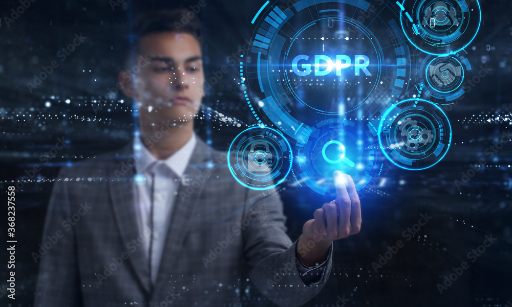 Business, Technology, Internet and network concept. Young businessman working on a virtual screen of the future and sees the inscription: GDPR Business, Technology, Internet and network concept. Young businessman working on a virtual screen of the future and sees the inscription: GDPR