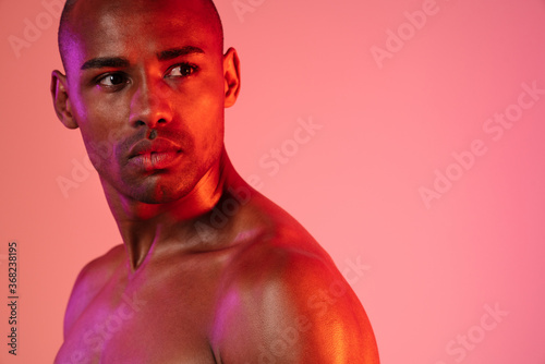 African fitness man posing isolated over neon wall