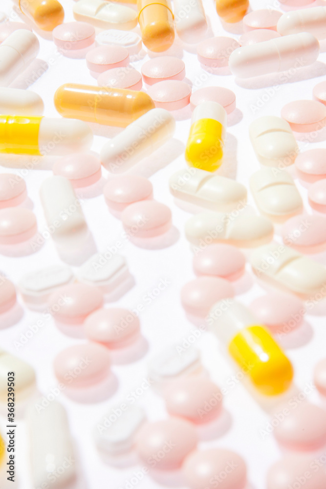 Multicolored pills and capsules isolated on the white background. Medical theme Multicolored pills and capsules isolated on the white background. Medical theme