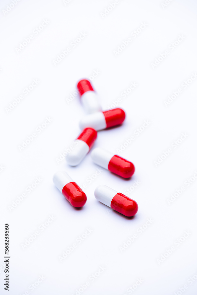 Capsule pills on white background, close-up of a drugs that could give addiction. Capsule pills on white background, close-up of a drugs that could give addiction.
