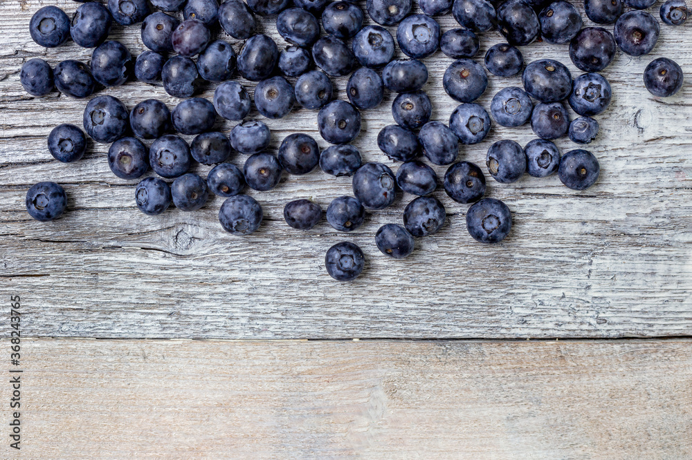 Blueberries on a white wooden background. Concept for healthy eating. Antioxidant organic superfood. Blueberries on a white wooden background. Concept for healthy eating. Antioxidant organic superfood.