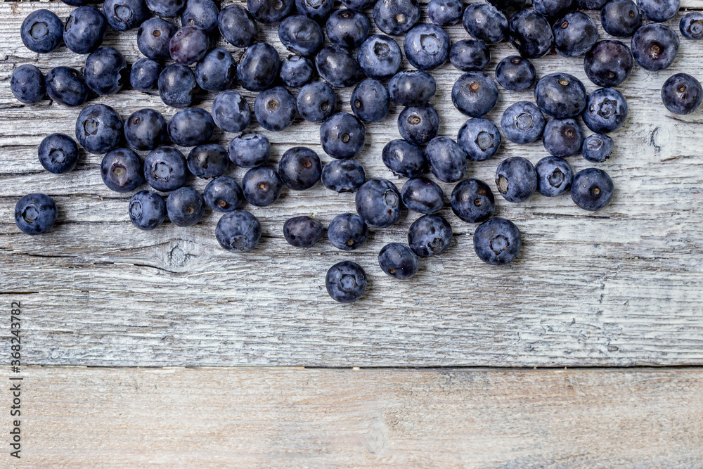 Blueberries on a white wooden background. Concept for healthy eating. Antioxidant organic superfood. Blueberries on a white wooden background. Concept for healthy eating. Antioxidant organic superfood.