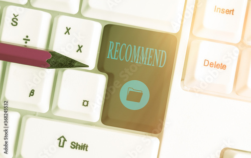 Text sign showing Recommend. Business photo showcasing present as worthy of acceptance or trial, make acceptable Different colored keyboard key with accessories arranged on empty copy space photo