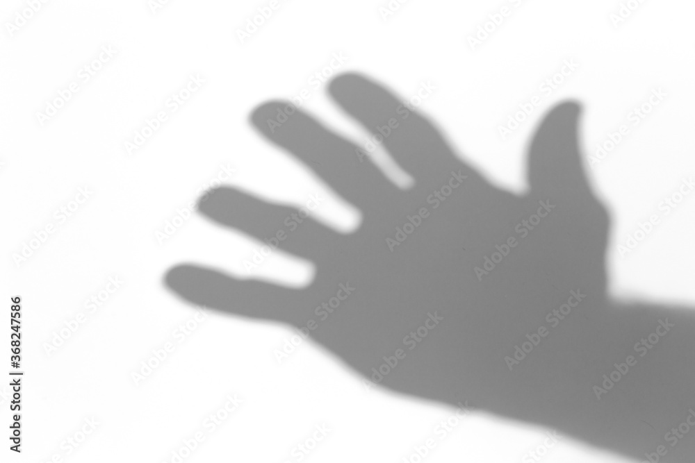 Fototapeta premium Shadow overlay effect for photo. Shadows from hand palms on white light wall in sunlight.