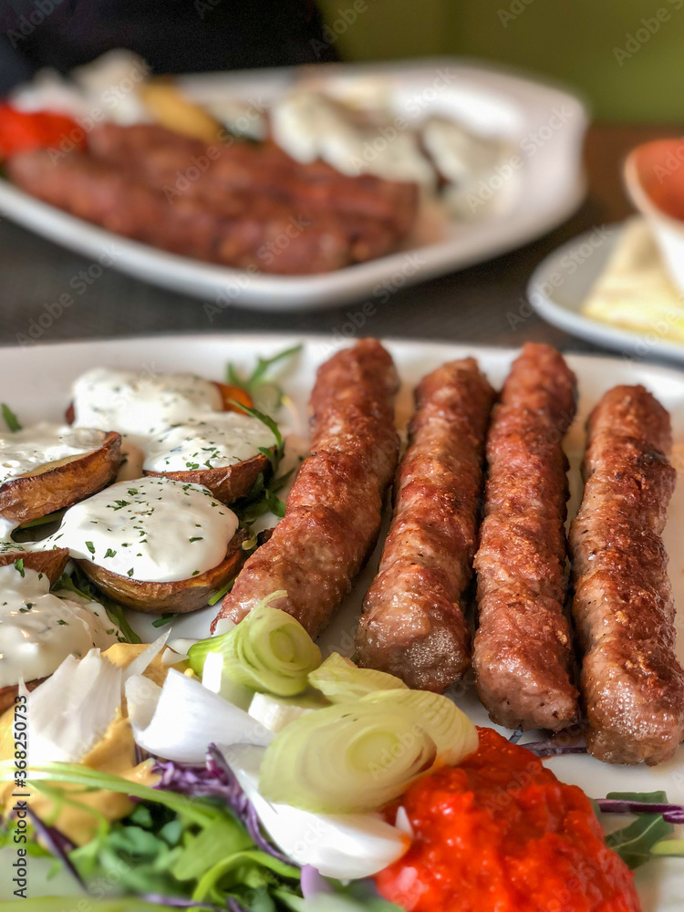 grilled meatballs and potatoes with salad on plate grilled meatballs and potatoes with salad on plate