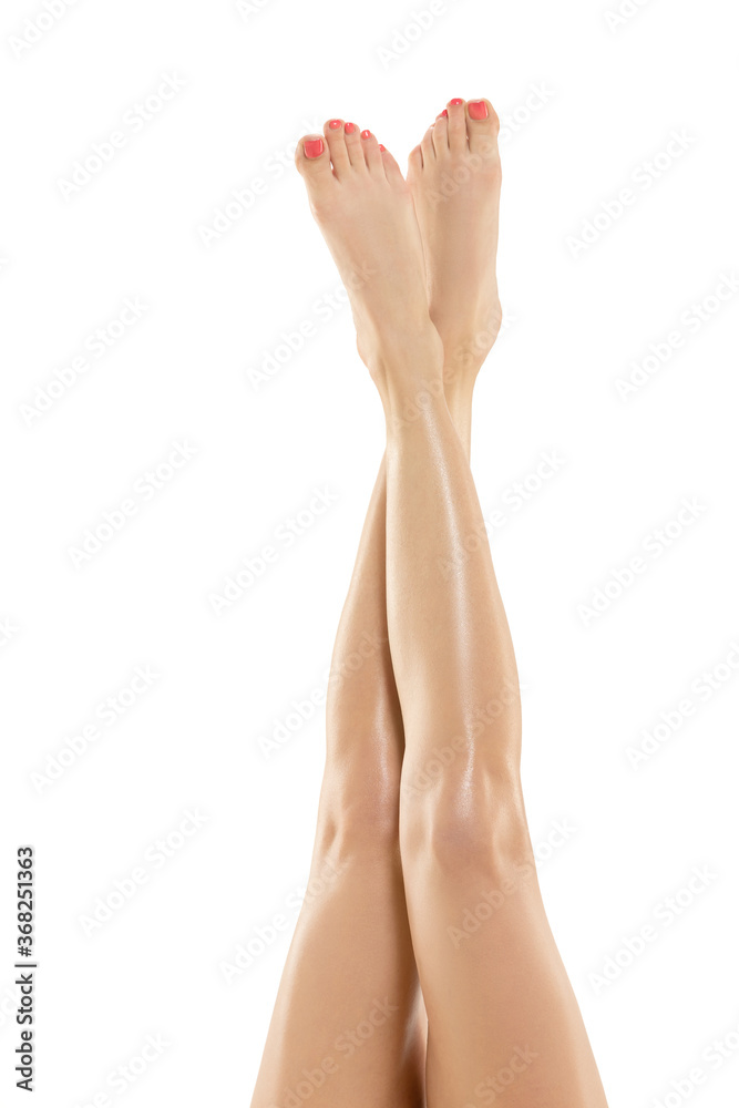 Tender touch. Beautiful female legs isolated on white background. Beauty, cosmetics, spa, depilation, treatment and fitness concept. Sportive, sensual body with well-kept skin in underwear. Tender touch. Beautiful female legs isolated on white background. Beauty, cosmetics, spa, depilation, treatment and fitness concept. Sportive, sensual body with well-kept skin in underwear.