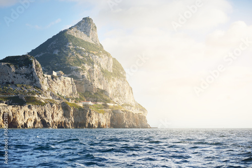 Rocky shores (cliffs, mountains) of the Europa Point, a view from the sailing boat. Gibraltar, British Overseas Territory. Travel destinations, national landmark, sightseeing theme
