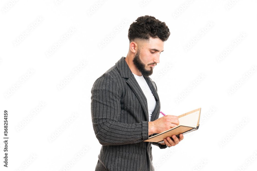 Just Inspired. Thoughtful Young Man In Suit Making Notes In His Pad