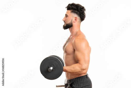 Muscular man working out doing exercises with dumbbells at biceps, strong male naked torso abs
