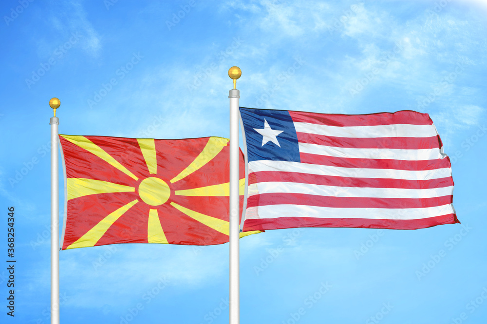 North Macedonia and Liberia two flags on flagpoles and blue sky