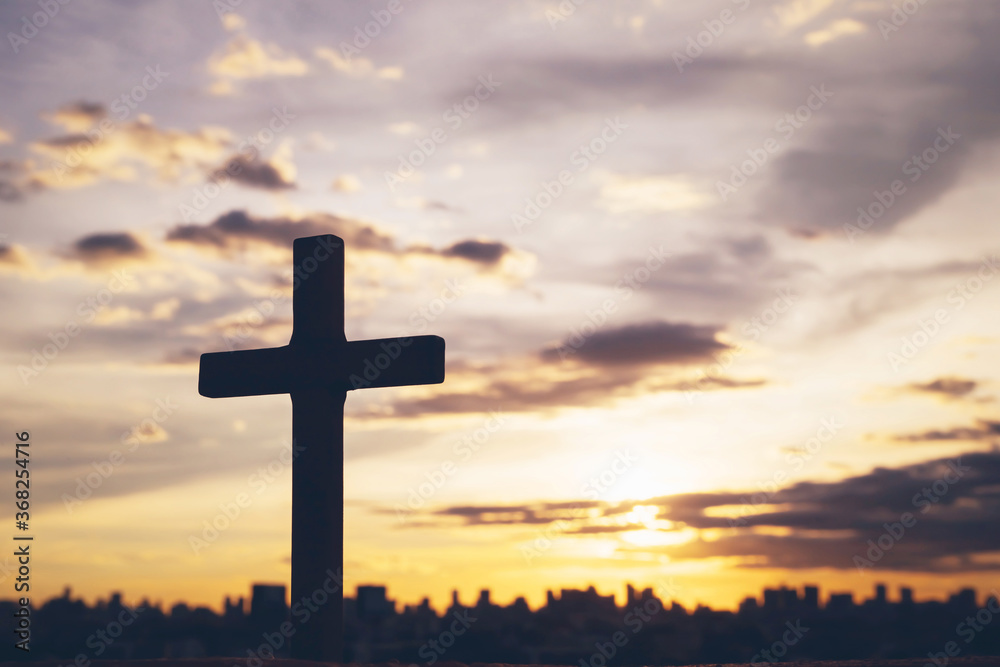Silhouette cross against the sky At Sunset. Dramatic nature background. Crucifixion Of Jesus Christ. Religion concept. Silhouette cross against the sky At Sunset. Dramatic nature background. Crucifixion Of Jesus Christ. Religion concept.