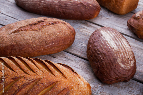 Natural organic bread assortment on wooden background. Healthy artisan bread. Bakery concept.