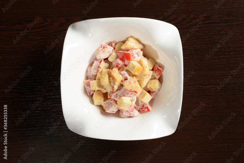 Salad with tomatoes cheese and fried bread, top view. Photos for restaurant and cafe menus
