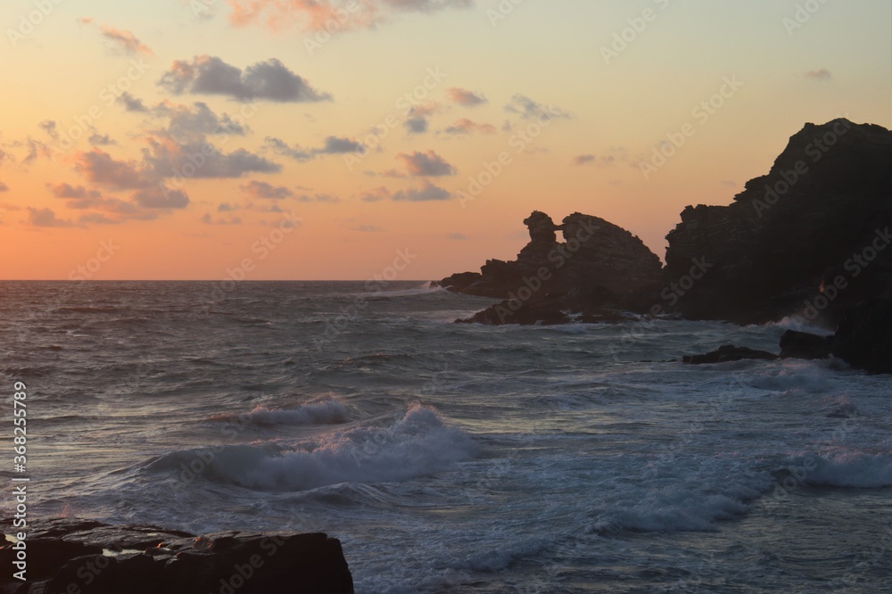Sunset at beach with window rock formation