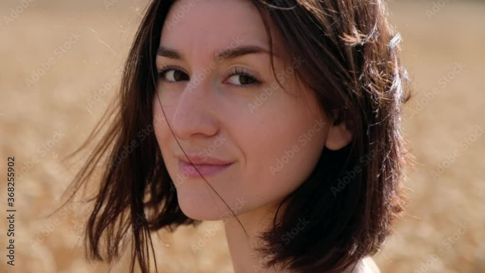 Portrait beautiful caucasian girl smiling turns head looking at camera with happy emotion Portrait beautiful caucasian girl smiling turns head looking at camera with happy emotion