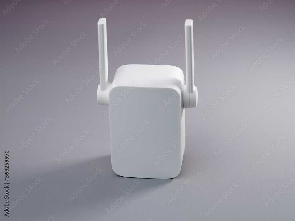 White Wireless WiFi repeater on gray background. White Wireless WiFi repeater on gray background.