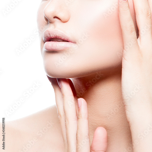 Part of beauty model girl face with hand near mouth. Perfect natural lips  clean skin  nude make-up  naked shoulder. Skincare facial treatment woman health concept.