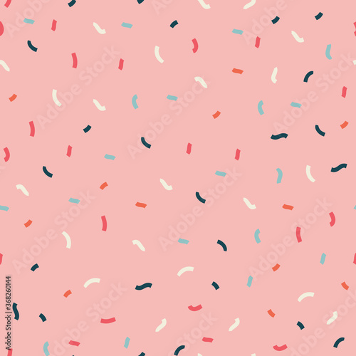 Seamless pattern of colored confetti background elements.