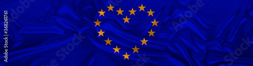 panorama of European Union flag on an delicate silk with folds, a heart of stars, the concept of historical, tourism, emigration, economics, politics, global world trade