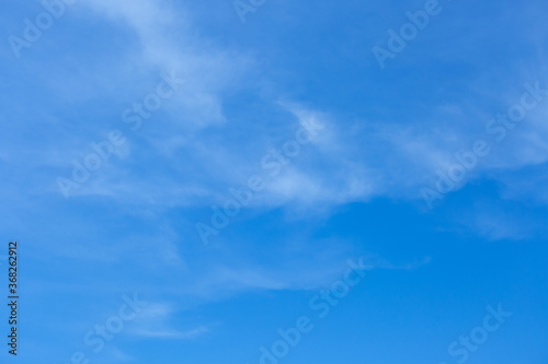 Blue sky background with tiny clouds.
