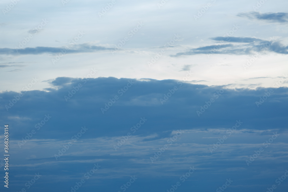 Blue sky background with tiny clouds.