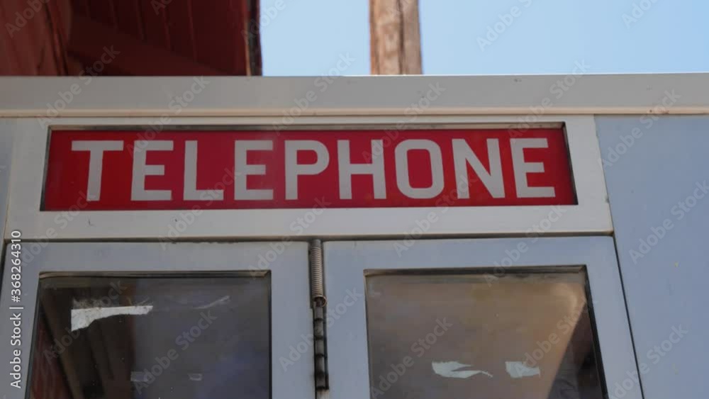 Door opening on an old time telephone booth Door opening on an old time telephone booth