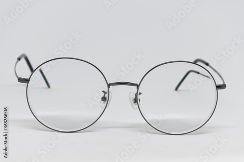Round frame myopia glasses with black glasses legs in a white scene