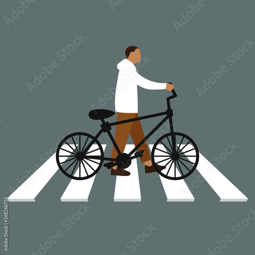 A man with a bicycle goes on a pedestrian crossing