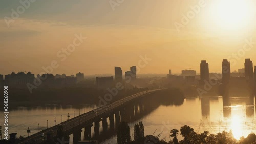Beautiful sunrise over the city, bridge over the river photo