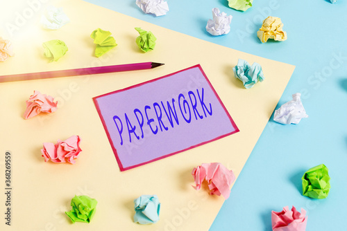 Conceptual hand writing showing Paperwork. Concept meaning routine clerical or recordkeeping work often incidental Colored crumpled papers empty reminder blue yellow clothespin photo
