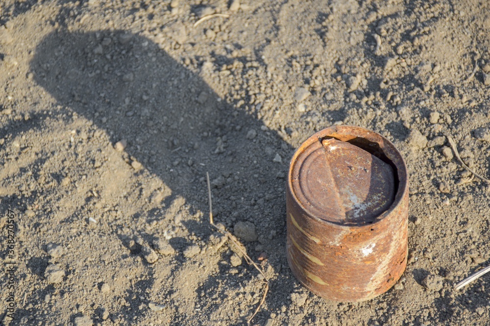 close up old rusty can on the ground close up old rusty can on the ground