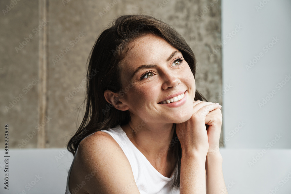 Image of beautiful joyful woman smiling and looking aside Image of beautiful joyful woman smiling and looking aside