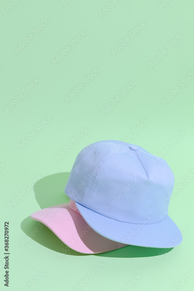 Urban style flat lay outfit fashion concept. Pastel colours aesthetics. Baseball Caps Urban style flat lay outfit fashion concept. Pastel colours aesthetics. Baseball Caps