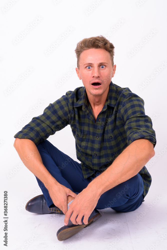Handsome man with blond curly hair against white background Handsome man with blond curly hair against white background