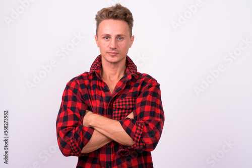 Handsome man with blond curly hair against white background