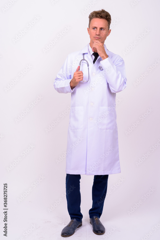Handsome man doctor with blond curly hair against white background Handsome man doctor with blond curly hair against white background