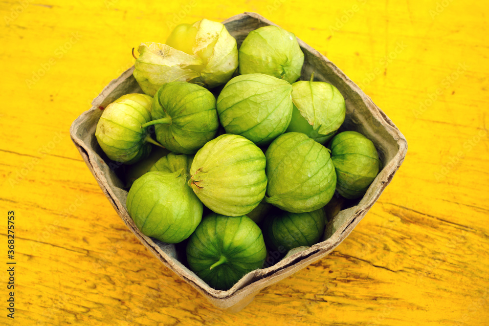 Containers of green tomatillo (Mexican husk tomato) Containers of green tomatillo (Mexican husk tomato)