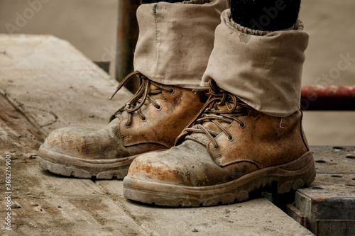 Rugged pair of brown tradesman's workboots on building site photo