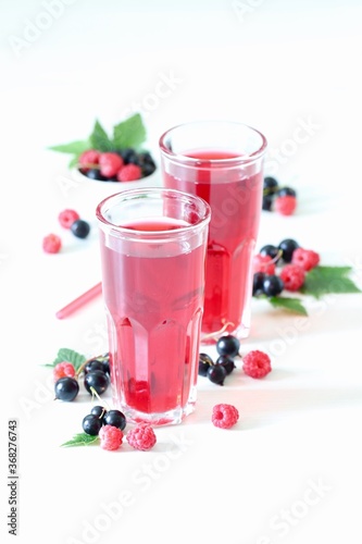 Wallpaper Mural Berry drink, compote of fresh raspberries and black currants in a glass on a white background Torontodigital.ca