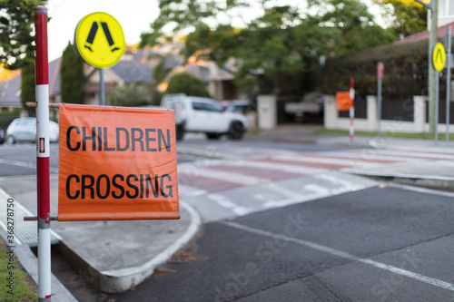 Children crossing sign on roadside at pedestrian crossing