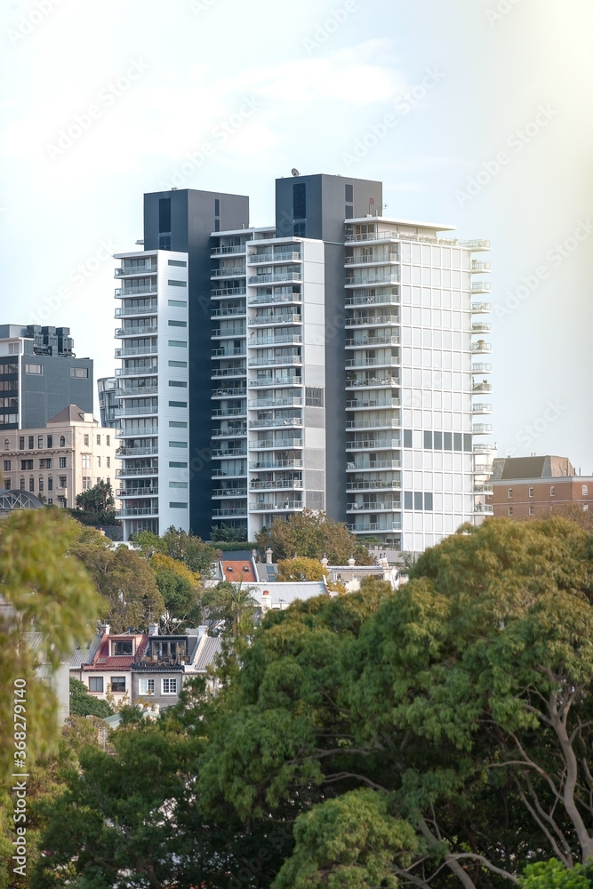 Apartment buildings and terraces among trees Apartment buildings and terraces among trees