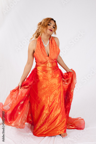 Lovely Hispanic woman playing with her dress