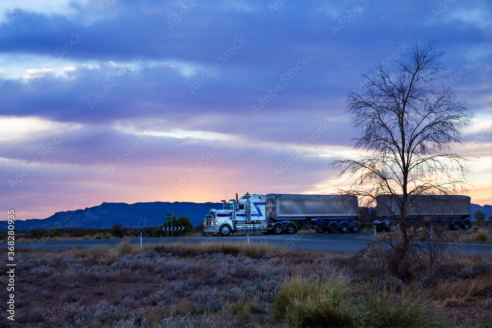 Truck travelling through remote location at dawn Truck travelling through remote location at dawn