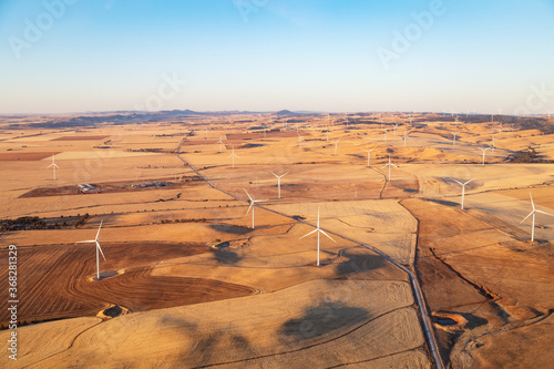 aerial view of wind turbines in farmland