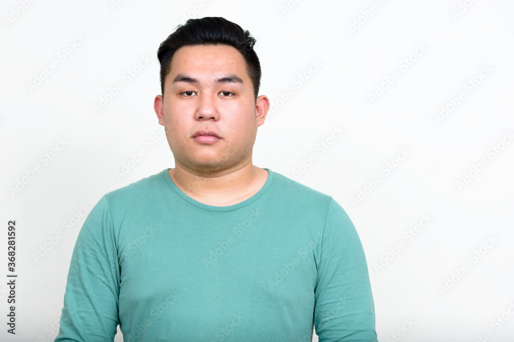 Fototapeta premium Portrait of young handsome overweight Asian man