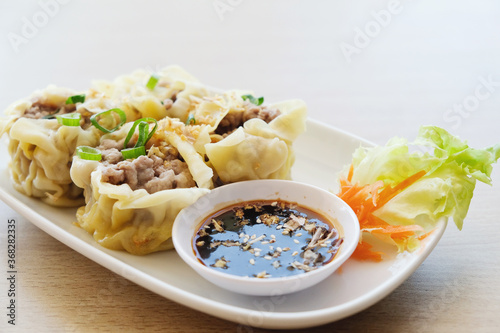 Pork dumpling; dim sum on white plate photo