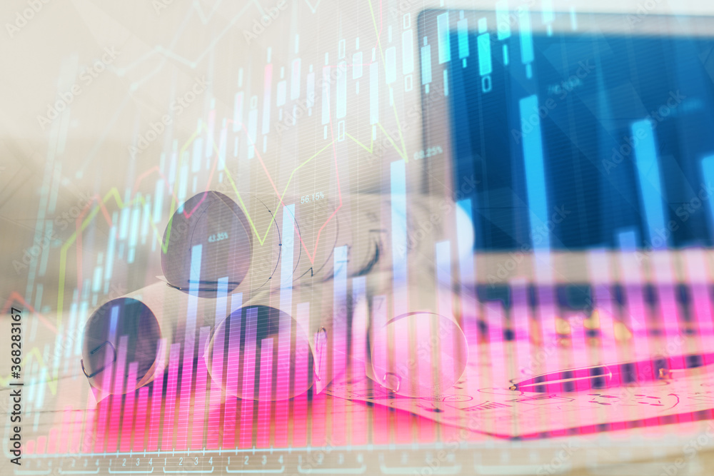 Forex market chart hologram and personal computer background. Double exposure. Concept of investment. Forex market chart hologram and personal computer background. Double exposure. Concept of investment.