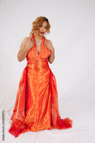 Lovely Hispanic woman in a flowing orange dress