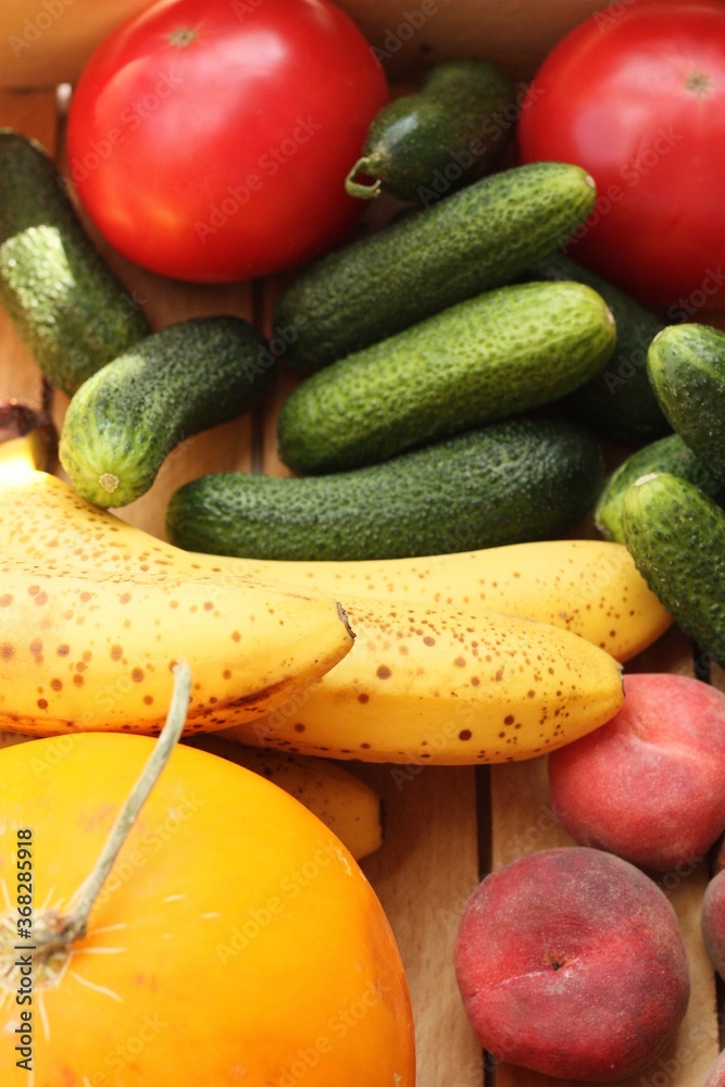 Seasonal fruits and vegetables in a wooden box Seasonal fruits and vegetables in a wooden box